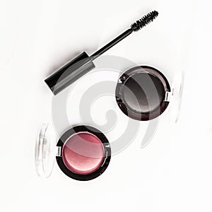 Eyeshadows, black liner and mascara on marble background, eye shadows cosmetics as glamour make-up products for luxury beauty