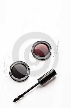 Eyeshadows, black liner and mascara on marble background, eye shadows cosmetics as glamour make-up products for luxury beauty