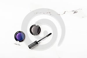 Eyeshadows, black liner and mascara on marble background, eye shadows cosmetics as glamour make-up products for luxury beauty