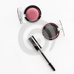 Eyeshadows, black liner and mascara on marble background, eye shadows cosmetics as glamour make-up products for luxury beauty