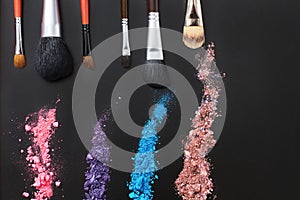 Eyeshadows and make up brushes on black background. Summer fashion style. Copy space. Mock up. Top view