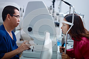 Eyesight exam with Asian doctor and patient