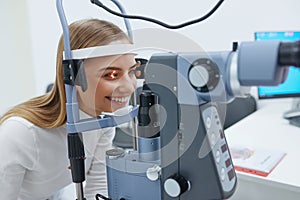 Eyesight Exam. Woman Checking Eye Vision On Optometry Equipment