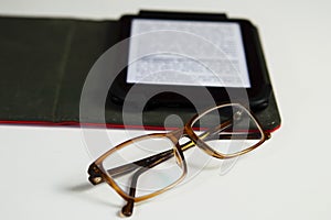 Eyestrain glasses and ebook reader isolated