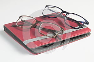 Eyestrain glasses and ebook reader isolated