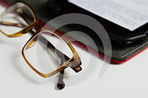 Eyestrain glasses and ebook reader isolated