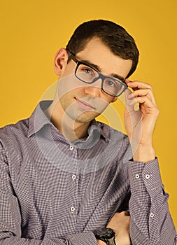 Eyewear. Choose eyeglasses in casual style. Smart boy. Bad eyesight. Cool guy wear eyeglasses yellow background. Man