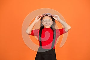 Eyewear fashion shop. Girl with eyeglasses orange background. Event and entertainment. Party celebration. Party