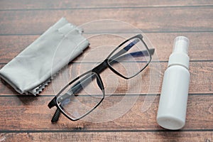 eyewear with spray and cleaning cloths on table