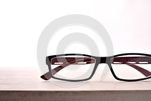 Eyewear on wood table and white background front view detail