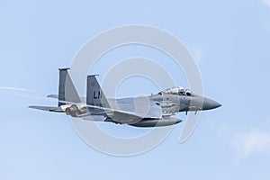 F-15E Strike Eagle trailing vapour as it climbs photo