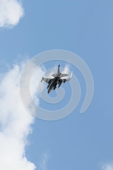 F16 fighter jet over clouds