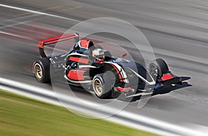 F1 race car racing on a track with motion blur photo
