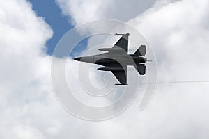 F16 war fighter jet over clouds