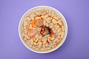 fabada asturiana, a typical spanish bean stew in white bowl photo