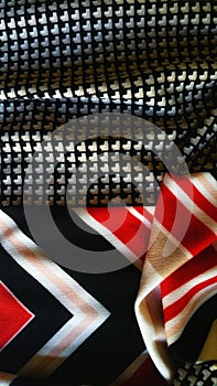 Fabric abstract. Red, black, gold and white. Mixed patterns.