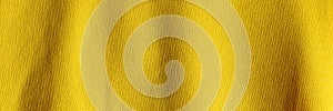 Fabric background with a yellow fabric cloth polyester texture. Wide banner