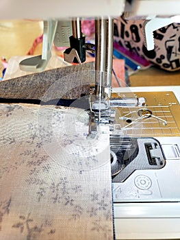 Fabric being sewn on sewing machine