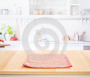 Fabric,cloth on wood table top on blur kitchen counter (room)background.For montage product display or design key visual