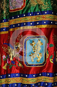 A fabric decorated with embroidered patterns is hung in a buddhist temple (Vietnam) photo