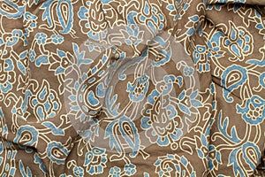 Fabric with drawings in blue and brown in a close up view