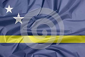 Fabric flag of Curacao. Crease of Curacao flag background.