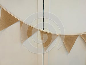 Fabric flag strips hanging left to right on the white folding door wall decorate for party