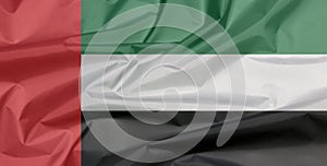 Fabric flag of United Arab Emirates. Crease of UAE flag background.