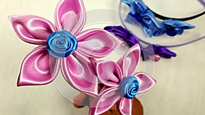 fabric flowers applied in hair accessories.  artesanal job.  beautiful crafts photo