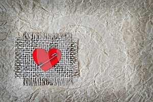 Fabric heart attached on canvas with safety pin