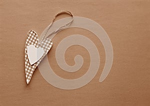 A fabric heart in Peach Fuzz on a paper background