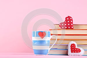 Fabric hearts with cup and stack of books