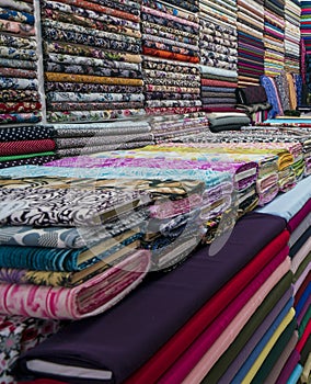 Fabric industry, textile store colorful fabric and silk. fabric background. cotton. Colorful rolls of fabrics for sale