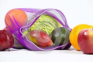 Fabric mesh for fruits and vegetables on a white background. A reusable alternative to plastic bags.