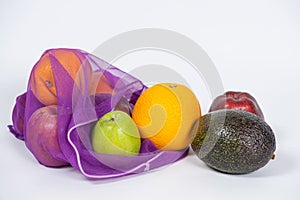 Fabric mesh for fruits and vegetables on a white background. A reusable alternative to plastic bags.