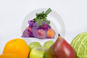 Fabric mesh for fruits and vegetables on a white background. A reusable alternative to plastic bags.