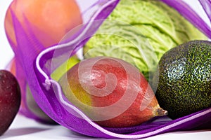 Fabric mesh for fruits and vegetables on a white background. A reusable alternative to plastic bags.