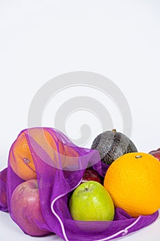 Fabric mesh for fruits and vegetables on a white background. A reusable alternative to plastic bags.