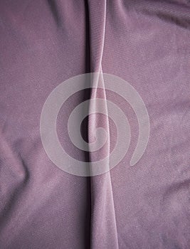 The fabric is pale pink with a matte surface. A crease in the middle.