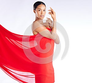 Fabric, red and portrait of woman for beauty, fashion and style isolated against a studio white background. Female