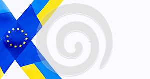 Fabric ribbons with national flag of Ukraine and  European Union on white background. Europe. Copy space. Empty space for message.