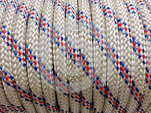 The fabric rope is wound in a bobbin with a uniform pattern. Close-up view of the entire frame