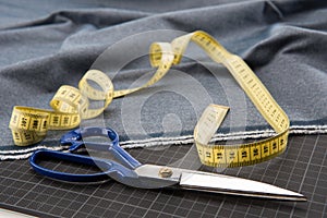 Fabric, scissors and measuring tape for dressmaking