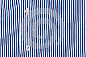 Fabric shirt with vertical stripes blue, light blue and white texture background.