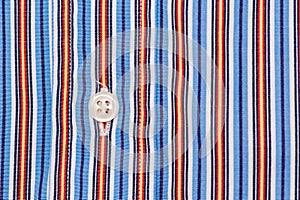 Fabric shirt with vertical stripes light blue, yellow,red and white texture background.