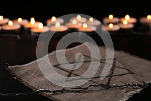 Fabric with star of David and barbed wire on black background. Holocaust memory day