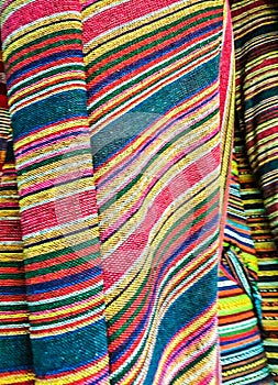 Fabric Store, Traditional fabric store with stacks of colorful textiles, fabric rolls at market stall - textile industry.