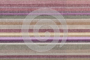Fabric striped texture. Rustic canvas pattern. Colored striped coarse linen fabric closeup as background