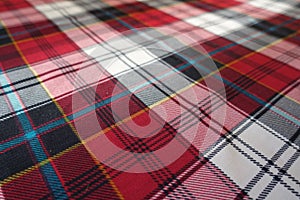 Fabric with tartan plaid pattern in red, black, white