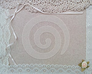 A fabric texture background surrounded by a frame of lace